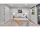 Well-lit bedroom showcasing neutral tones, soft carpet, and a comfortable bed with stylish accents at 401 Sanders St, Indianapolis, IN 46225