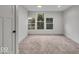 Bright bedroom with three windows overlooking a tree-lined street, showcasing comfort and style at 401 Sanders St, Indianapolis, IN 46225