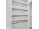 White walk-in closet with multiple wire rack shelves for optimal storage and organization of belongings at 401 Sanders St, Indianapolis, IN 46225