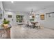 Bright dining room with white walls, wood floors, modern chandelier, and a wooden dining table with seating for six at 401 Sanders St, Indianapolis, IN 46225