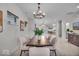 Open-concept dining area with a statement chandelier and views of the kitchen and living spaces at 401 Sanders St, Indianapolis, IN 46225