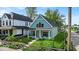 Charming two-story home with a classic American design, complemented by a welcoming front porch and a well-manicured lawn at 401 Sanders St, Indianapolis, IN 46225