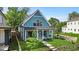 Inviting two-story home with classic details, front porch, updated colors, and a well-kept front yard with a walkway at 401 Sanders St, Indianapolis, IN 46225