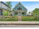 Charming two-story home featuring a decorative wooden fence and freshly manicured lawn at 401 Sanders St, Indianapolis, IN 46225