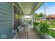 Cozy front porch with seating, plants, and view of neighborhood at 401 Sanders St, Indianapolis, IN 46225