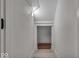Hallway with hardwood-style floors leads to additional rooms, offering a clean and bright transition space at 401 Sanders St, Indianapolis, IN 46225