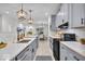 Modern kitchen featuring gray cabinets, stainless steel appliances, a subway tile backsplash, and an island with white countertop at 401 Sanders St, Indianapolis, IN 46225