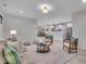 Open-concept living space with hardwood floors, stainless steel appliances, and modern kitchen leading to the dining area at 401 Sanders St, Indianapolis, IN 46225
