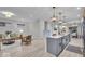 Open-concept living space with hardwood floors and views of the modern kitchen and dining areas at 401 Sanders St, Indianapolis, IN 46225