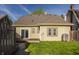 Back exterior of the house has brown shingles and wooden fence at 4247 Central Ave, Indianapolis, IN 46205