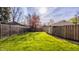Expansive backyard featuring green grass, wood fence perimeter, and detached garage at 4247 Central Ave, Indianapolis, IN 46205