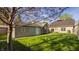View of the backyard featuring detached garage, house and mature tree at 4247 Central Ave, Indianapolis, IN 46205