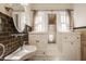 Charming bathroom with custom sink, natural light and decorative tiling throughout at 4247 Central Ave, Indianapolis, IN 46205