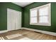 Spacious bedroom features a large window and closet space, perfect for relaxation at 4247 Central Ave, Indianapolis, IN 46205