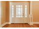 Bright entryway featuring beautiful hardwood floors and a white door with windows at 4247 Central Ave, Indianapolis, IN 46205