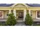 Close-up of a home's front door and porch, framed by small trees at 4247 Central Ave, Indianapolis, IN 46205