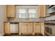 Well-lit kitchen features light wood cabinets and backsplash at 4247 Central Ave, Indianapolis, IN 46205