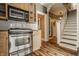 Kitchen featuring modern appliances and an open staircase at 4247 Central Ave, Indianapolis, IN 46205