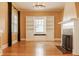 Bright living room featuring hardwood floors, fireplace, and custom built-in shelving at 4247 Central Ave, Indianapolis, IN 46205