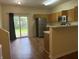 Bright kitchen with stainless steel appliances, wood cabinets, and sliding glass doors leading to the backyard at 4932 Tuscany Ln, Indianapolis, IN 46254
