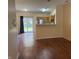 View of an open-concept floor plan with kitchen, living, and dining areas connected by sleek, modern flooring at 4932 Tuscany Ln, Indianapolis, IN 46254