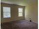 Neutral bedroom featuring neutral carpet, and two windows offering natural light at 4932 Tuscany Ln, Indianapolis, IN 46254