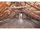 Spacious unfinished attic with exposed insulation, beams, and hardwood flooring at 5074 E Walnut St, Indianapolis, IN 46201