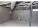 Basement features painted concrete walls, floor, and exposed utilities at 5074 E Walnut St, Indianapolis, IN 46201