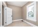 Bedroom with a window letting in light and a closet with a white door at 5074 E Walnut St, Indianapolis, IN 46201