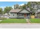 Charming single-Gathering home featuring a cozy front porch and a well-manicured lawn at 5074 E Walnut St, Indianapolis, IN 46201