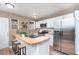 Modern kitchen featuring stainless steel appliances, a butcher block island, and white cabinets at 5074 E Walnut St, Indianapolis, IN 46201