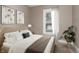 Serene bedroom with a comfortable bed, soft lighting, and a view from the window at 5074 E Walnut St, Indianapolis, IN 46201
