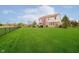 Expansive backyard featuring a well-maintained lawn, mature trees, and a secure fence at 5196 E County Road 100 S, Avon, IN 46123