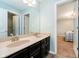 Bathroom featuring a double vanity with modern fixtures and an adjoining door to the bedroom at 5196 E County Road 100 S, Avon, IN 46123