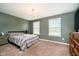 Cozy bedroom with soft carpeting, neutral-toned walls, and ample natural light from two windows at 5196 E County Road 100 S, Avon, IN 46123