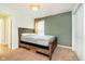 Inviting bedroom featuring a charming green accent wall, soft carpet, and double door closet at 5196 E County Road 100 S, Avon, IN 46123