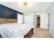 Well-lit bedroom showcasing a wood-framed bed, a striking blue accent wall and natural light at 5196 E County Road 100 S, Avon, IN 46123