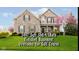 Charming two-story home with a stone facade, manicured lawn, and a beautiful flowering tree at 5196 E County Road 100 S, Avon, IN 46123