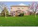 Two story home with brick and siding exterior, a deck, and a lush green lawn at 5196 E County Road 100 S, Avon, IN 46123