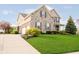 Two-story home boasts stone and siding, attached garage, and a well-maintained lawn at 5196 E County Road 100 S, Avon, IN 46123
