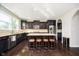 Spacious kitchen with dark wood cabinets, granite countertops, and a large center island at 5196 E County Road 100 S, Avon, IN 46123