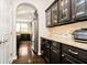 Gourmet kitchen with dark cabinets, granite countertops, and stainless steel appliances at 5196 E County Road 100 S, Avon, IN 46123