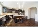 Modern kitchen with a large island, granite countertops, stainless steel appliances, and dark hardwood floors at 5196 E County Road 100 S, Avon, IN 46123