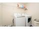 Functional laundry room with modern washer and dryer units and ample storage shelving at 5196 E County Road 100 S, Avon, IN 46123