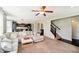 Open floorplan living room featuring stairs, archways, and access to the kitchen and dining areas at 5196 E County Road 100 S, Avon, IN 46123