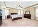 Spacious main bedroom with a tray ceiling, ceiling fan, and dark wood furniture at 5196 E County Road 100 S, Avon, IN 46123