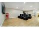 Entertainment room featuring leather recliners, a big screen TV, and a basketball game in the background at 5196 E County Road 100 S, Avon, IN 46123