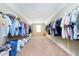 Spacious walk-in closet featuring ample storage with shelving and hanging rods on both sides at 5196 E County Road 100 S, Avon, IN 46123