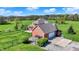 Aerial view of a brick home with an attached garage and a spacious, fenced yard at 5299 W Pr Black Hawk, Edinburgh, IN 46124