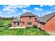 Brick home with a concrete patio and a spacious, green lawn enclosed by a chain-link fence at 5299 W Pr Black Hawk, Edinburgh, IN 46124